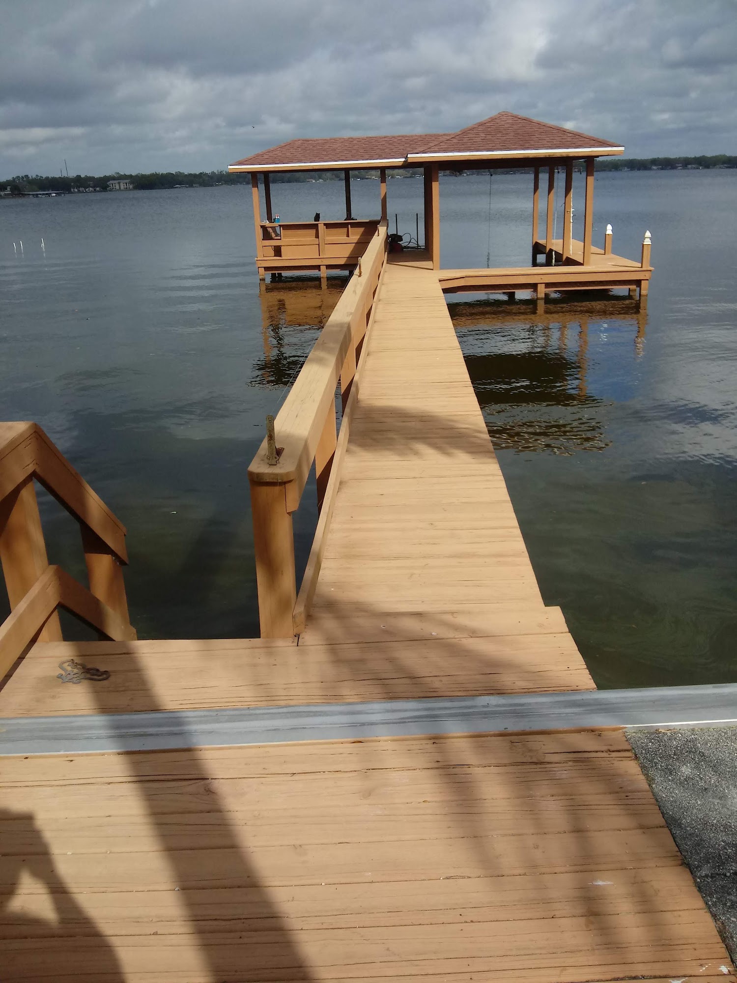 Fresh wooden walkway leading to a covered dock