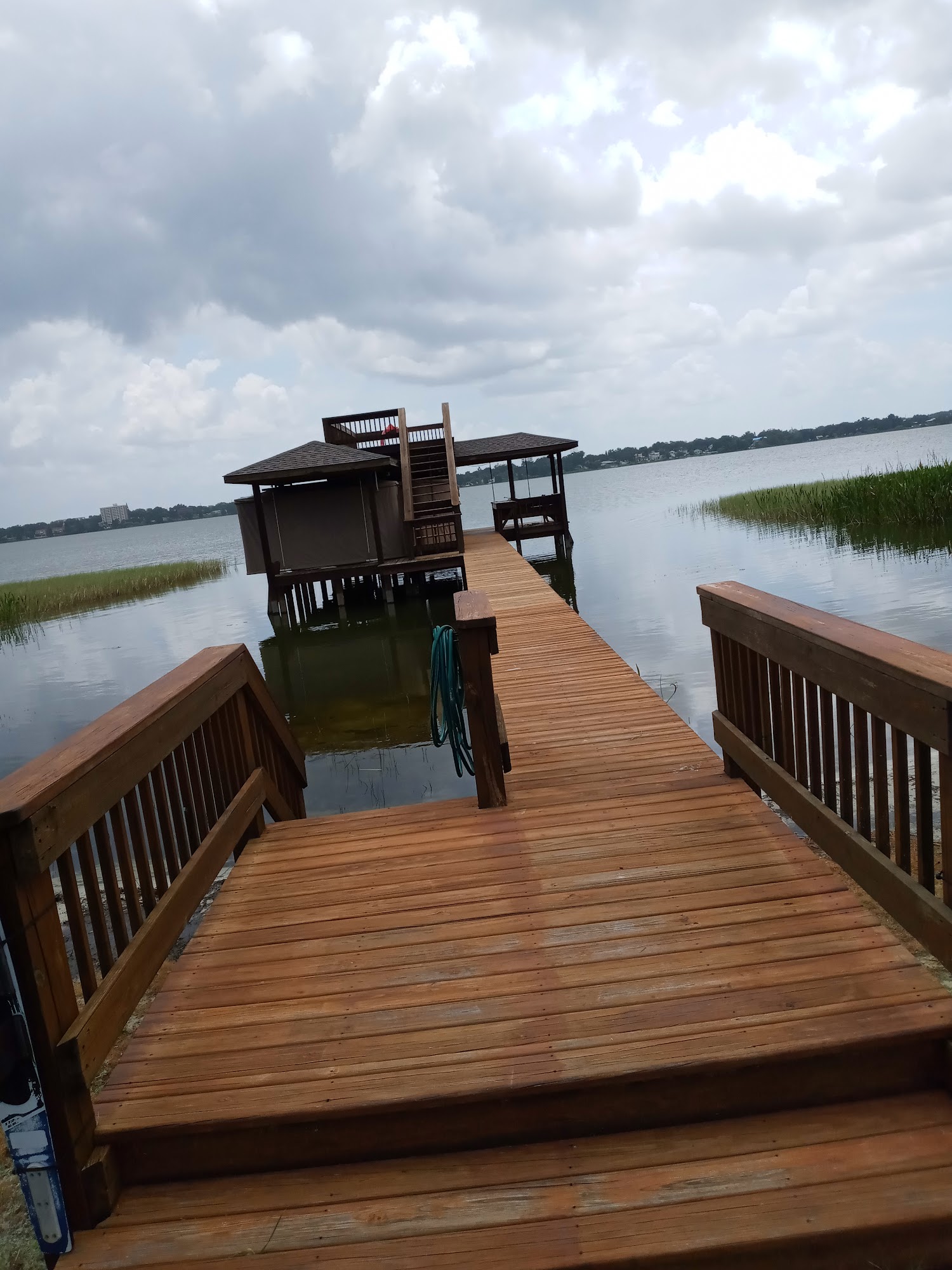 Long restored dock leading to a covered structure