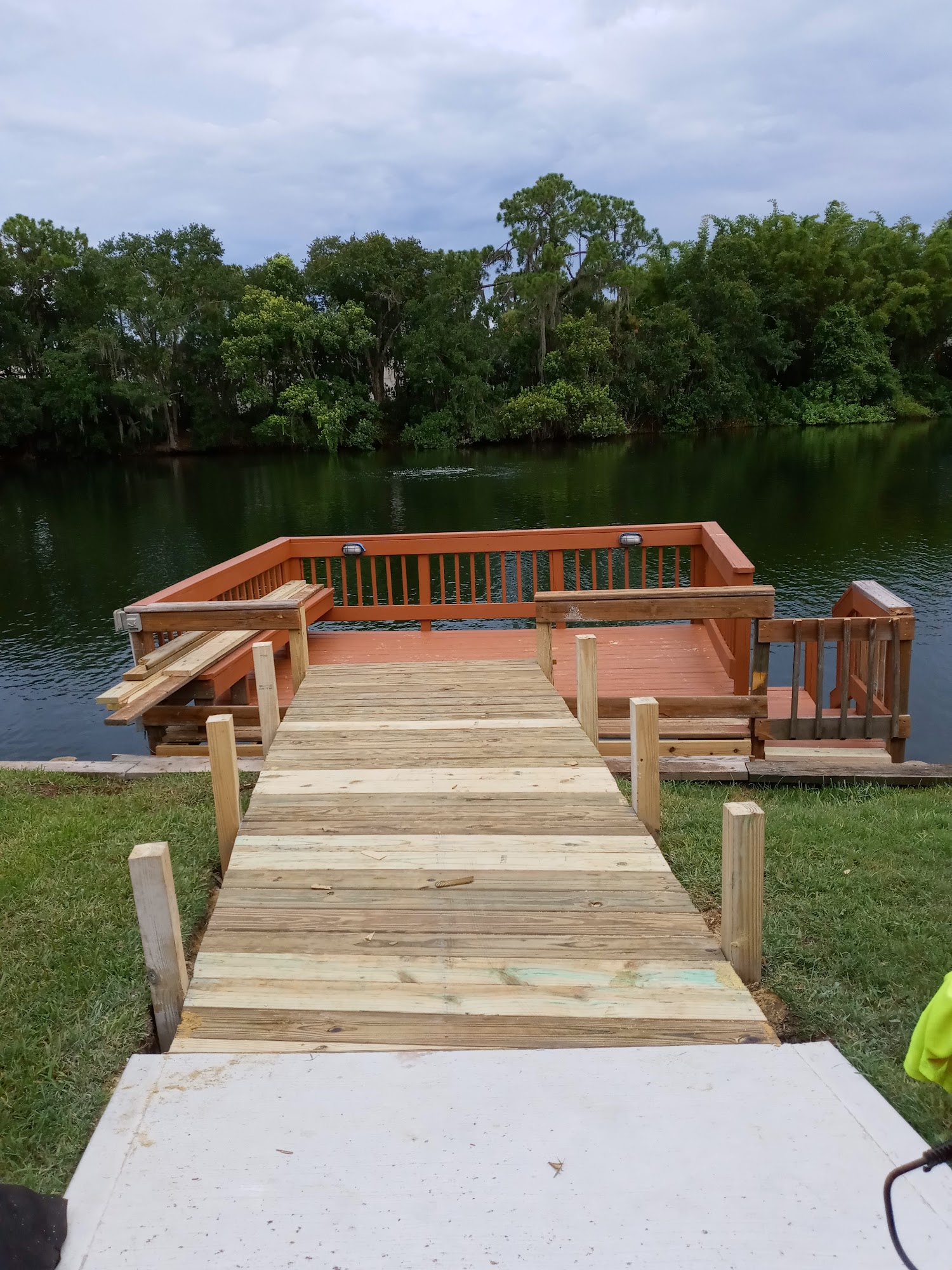 New wide stairs and wooden handrails from lawn to waterfront
