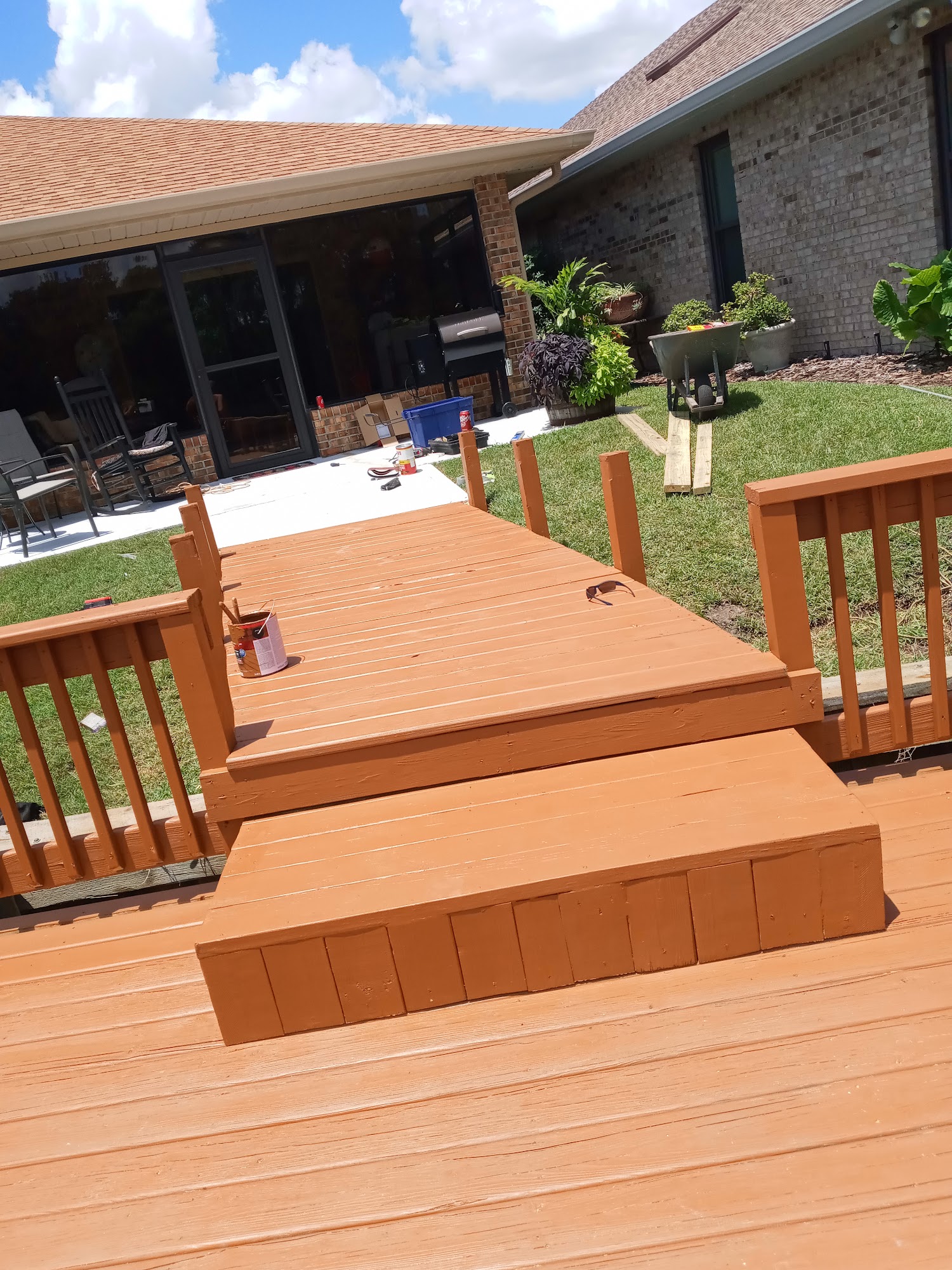New composite deck and broad steps in a backyard