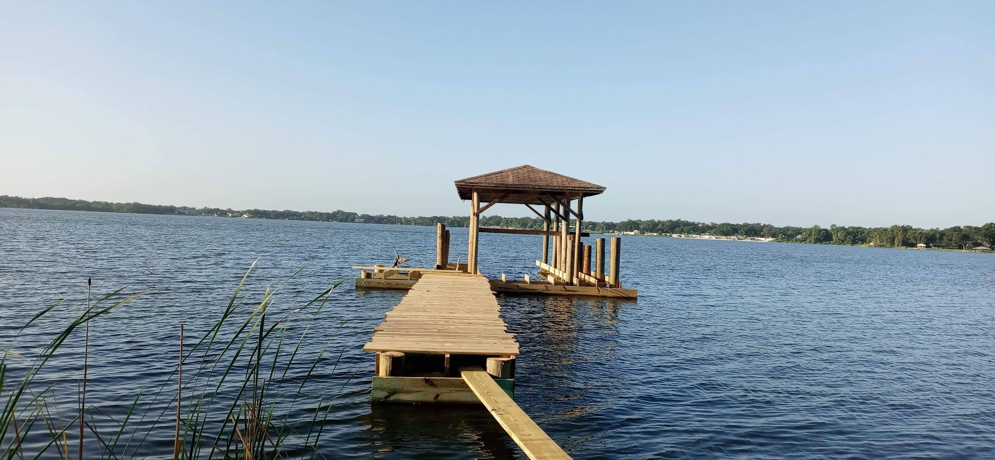Wooden walkway and covered platform on a broad lake