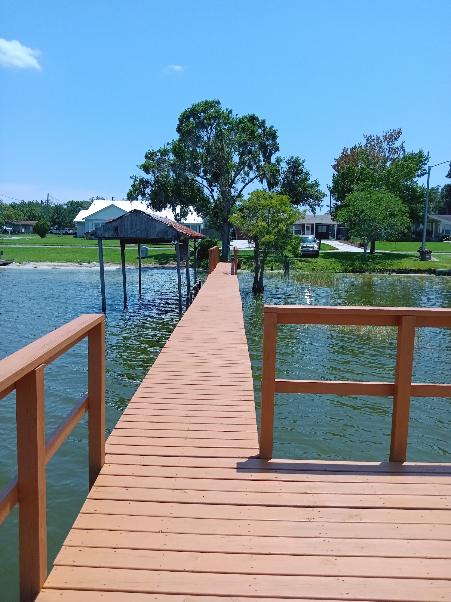 New wooden walkway leading toward a covered dock