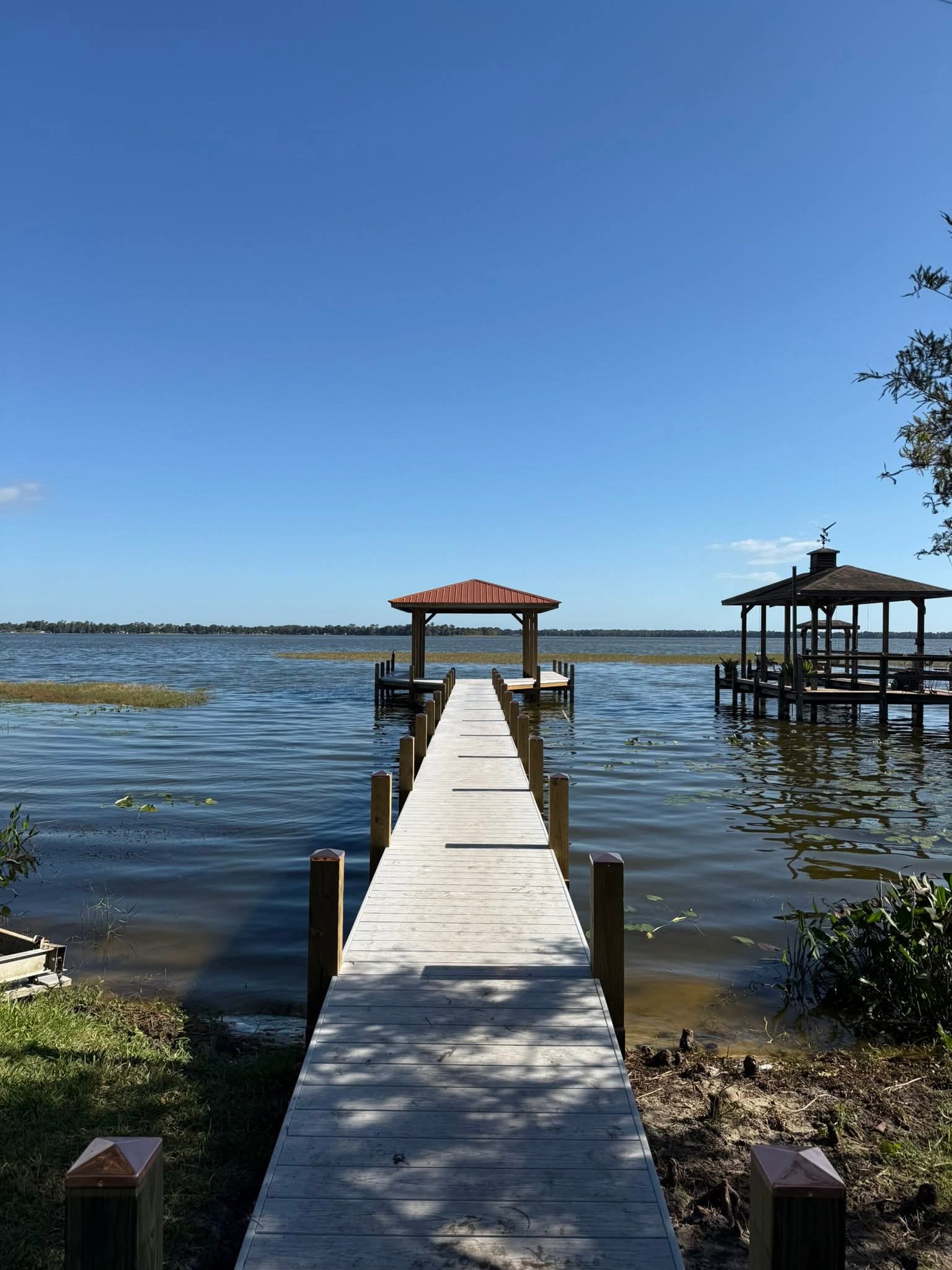 Clean finished dock leading straight to a copper-colored roof pavilion